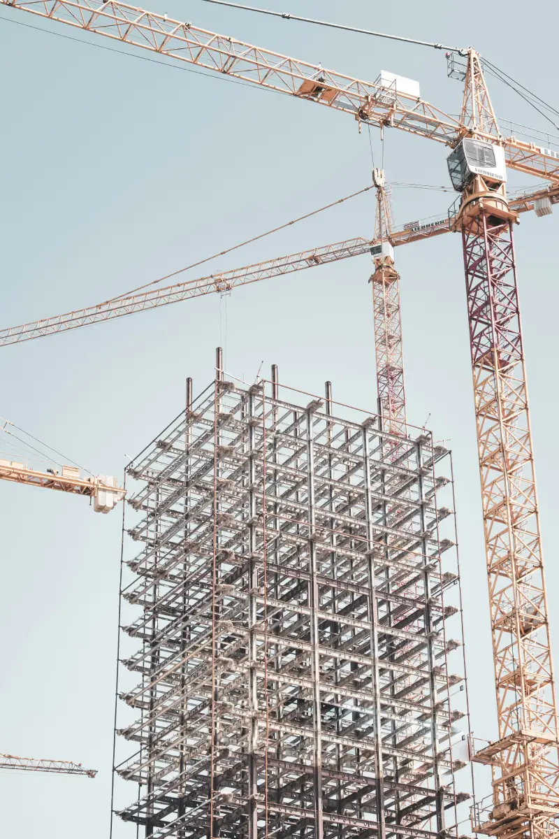 Industrial steel building frame with tower crane — structural platform construction