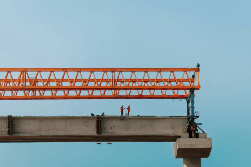Steel erection — workers assembling structural steel components on construction site
